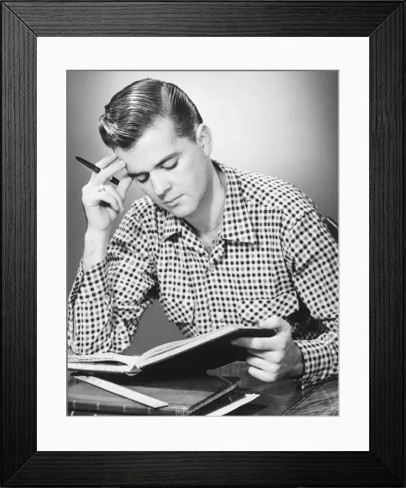 Framed Print : Male student reading, (B&W) Framed Print : Male student reading, (B&W)