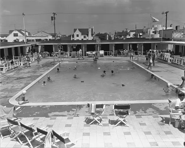 People swimming in pool, (B&W), elevated view
