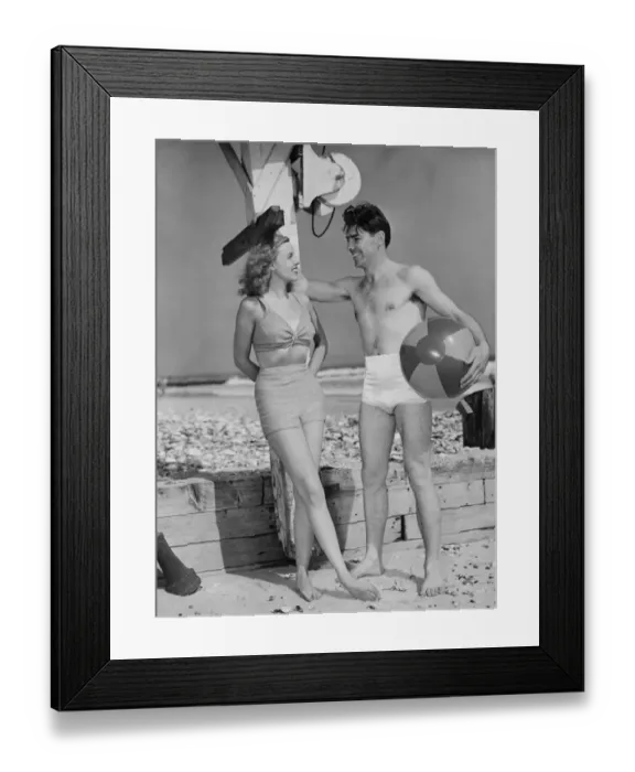 Framed Print : Couple standing on beach, talking, (B&W) Framed Print : Couple standing on beach, talking, (B&W)