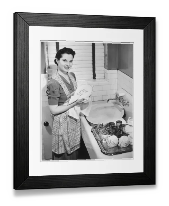 Framed Print : Woman drying dishes at kitchen sink, (B&W), elevated view Framed Print : Woman drying dishes at kitchen sink, (B&W), elevated view
