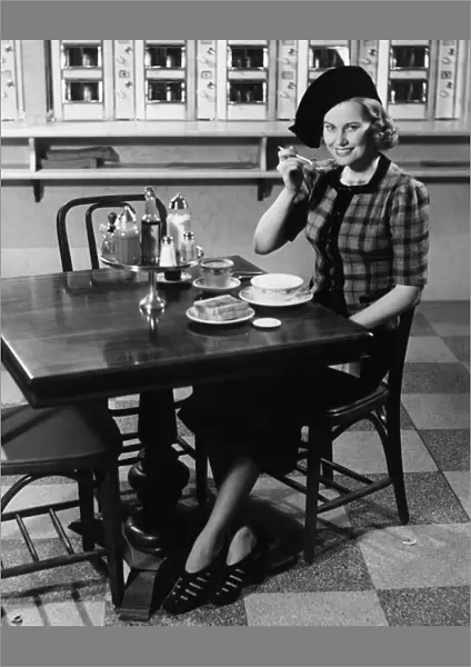 Woman in fancy hat eating breakfast in bar, (B&W), portrait