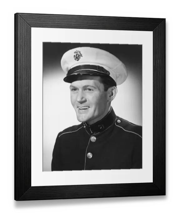Framed Print : Smiling man in military uniform posing in studio, (B&W), portrait Framed Print : Smiling man in military uniform posing in studio, (B&W), portrait
