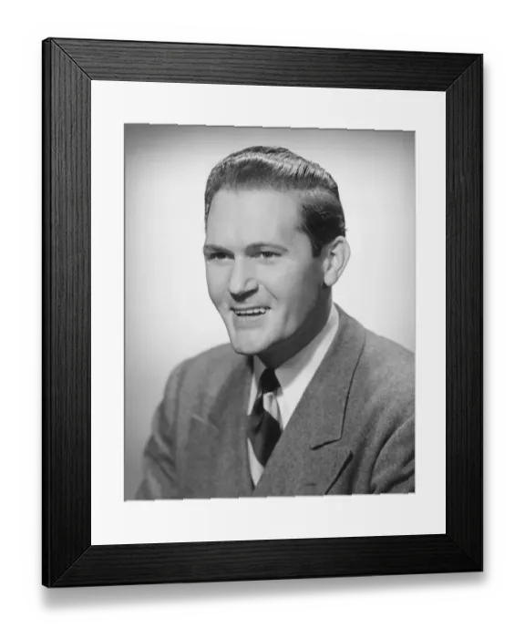 Framed Print : Smiling man in studio, (B&W), portrait Framed Print : Smiling man in studio, (B&W), portrait
