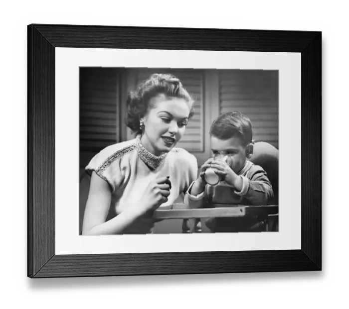Framed Print : Mother assisting son (2-3) drinking milk, (B&W)