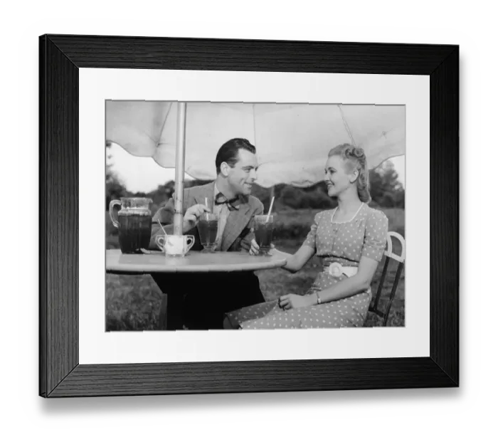 Framed Print : Couple having ice tea outdoors, (B&W) Framed Print : Couple having ice tea outdoors, (B&W)