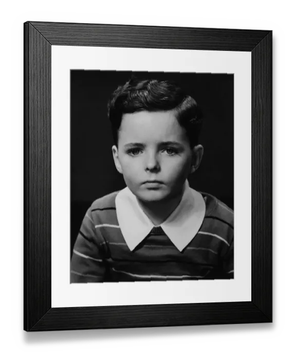 Framed Print : Boy (6-7) posing in studio, (B&W), portrait