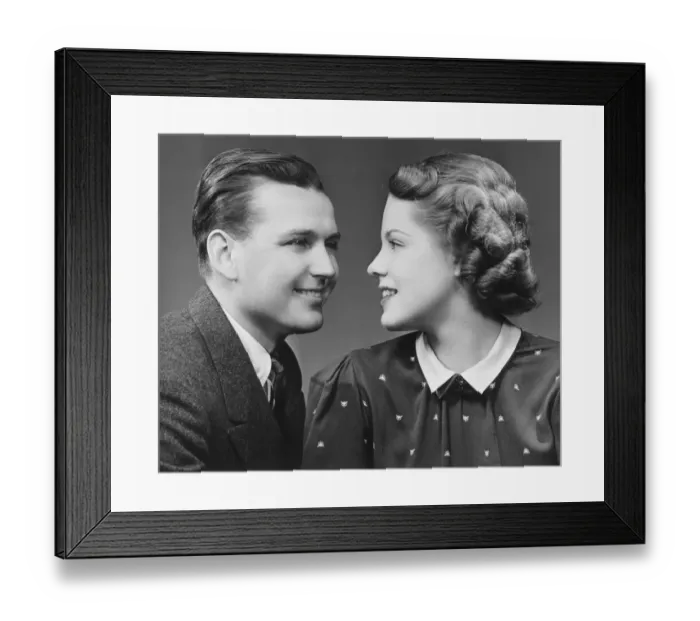Framed Print : Young couple looking in eyes in studio, (B&W), portrait Framed Print : Young couple looking in eyes in studio, (B&W), portrait