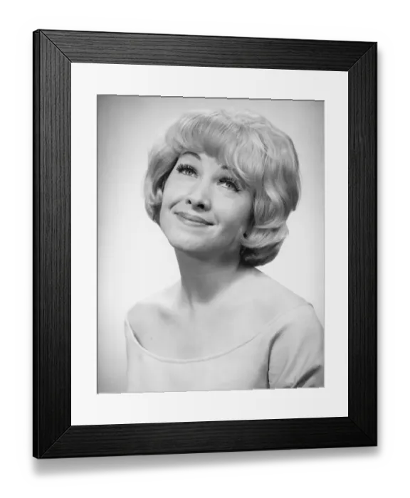 Framed Print : Smiling woman posing in studio, (B&W), portrait