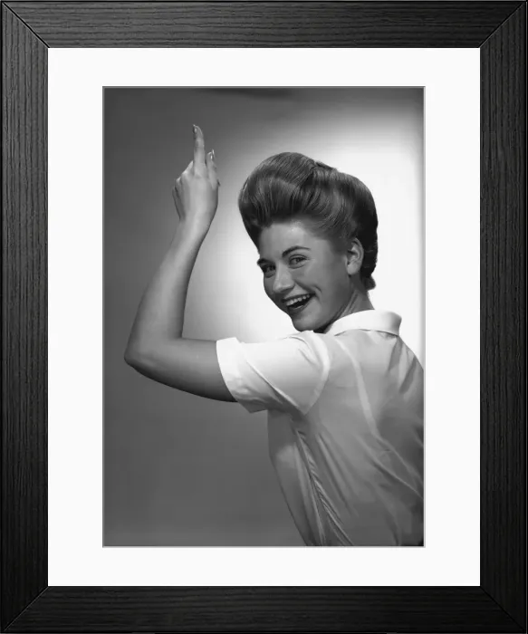 Framed Print : Woman pointing up in studio, (B&W), portrait Framed Print : Woman pointing up in studio, (B&W), portrait