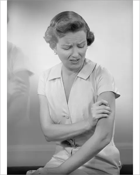 Woman massaging arm