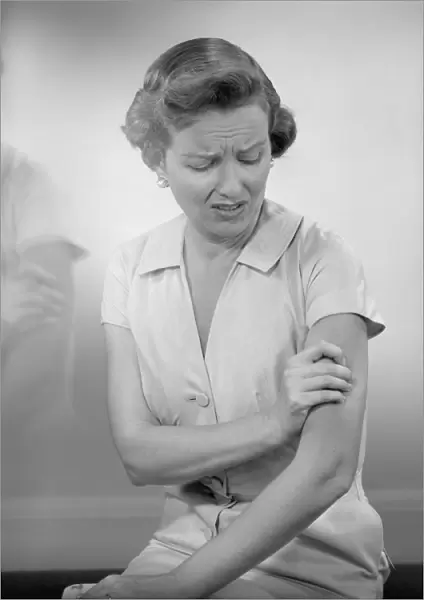 Woman massaging arm