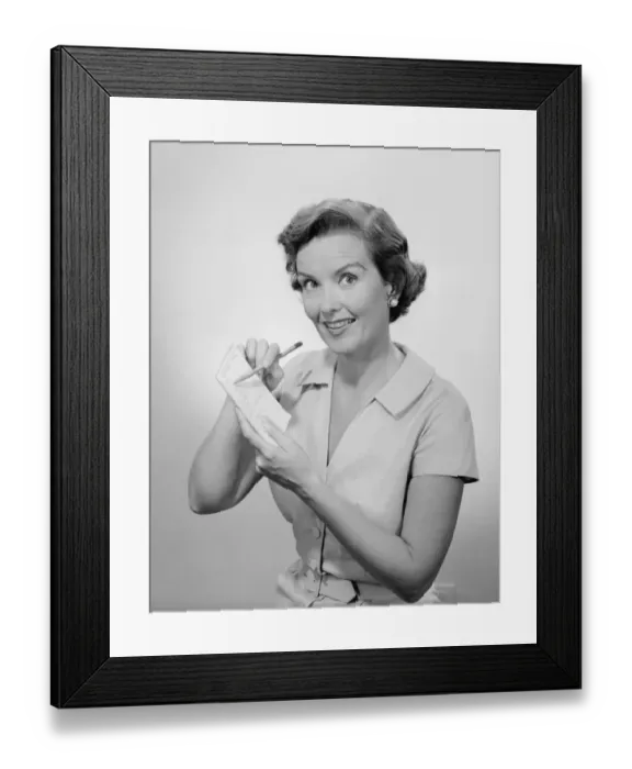 Framed Print : Woman writing list, studio portrait Framed Print : Woman writing list, studio portrait