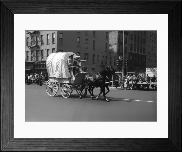 Framed Print : Covered Wagon on street during parade Framed Print : Covered Wagon on street during parade