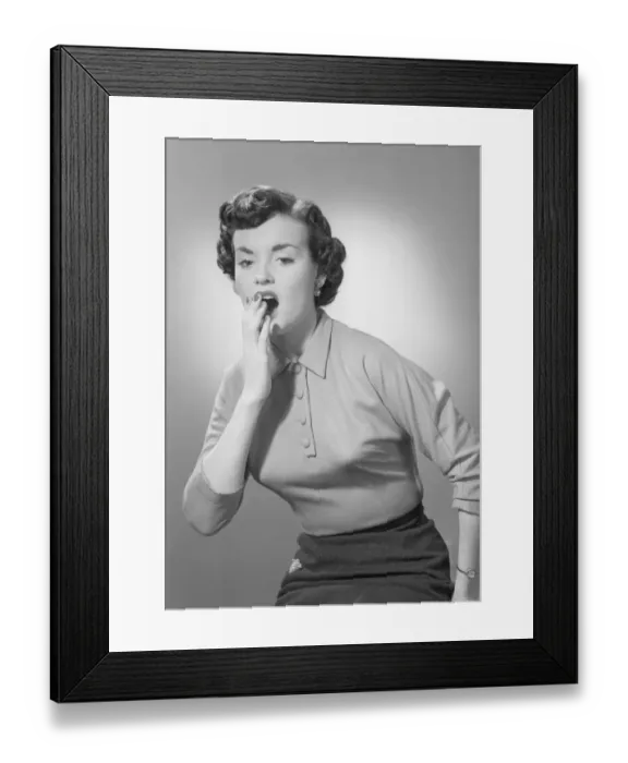 Framed Print : Studio portrait of woman yawning Framed Print : Studio portrait of woman yawning