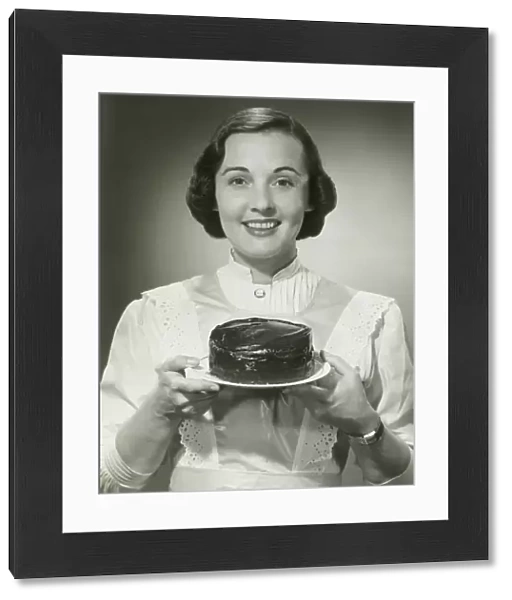 Studio portrait of woman holding cake