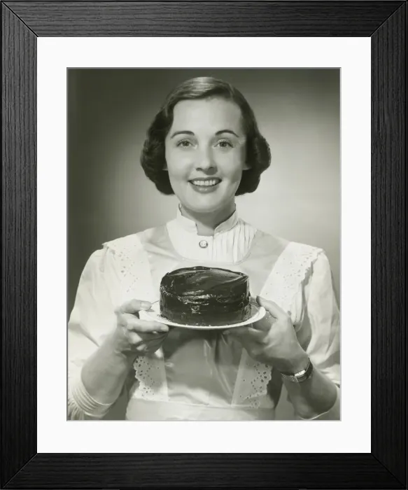 Framed Print : Studio portrait of woman holding cake Framed Print : Studio portrait of woman holding cake