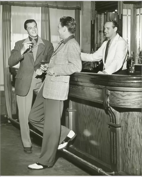 Two men talking at bar counter