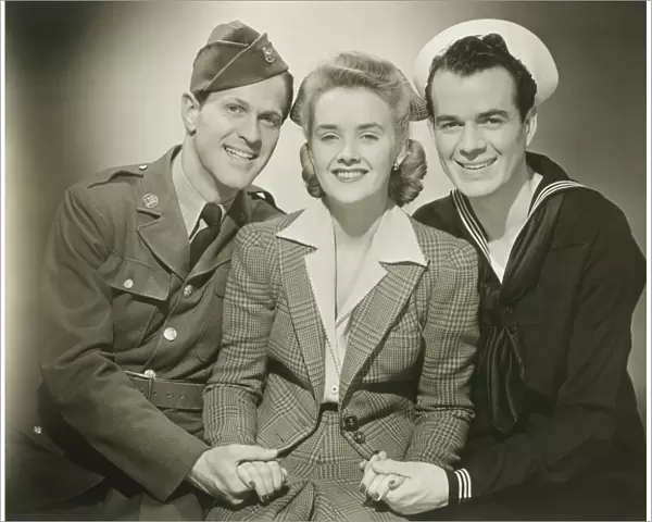 Portrait of mature woman with soldier and sailor, smiling