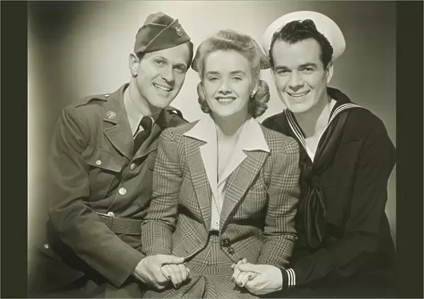 Portrait of mature woman with soldier and sailor, smiling