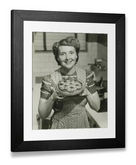 Framed Print : Portrait of mature woman holding pie Framed Print : Portrait of mature woman holding pie