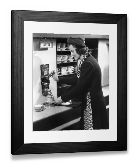 Framed Print : Woman getting coffee at old fashioned machine Framed Print : Woman getting coffee at old fashioned machine