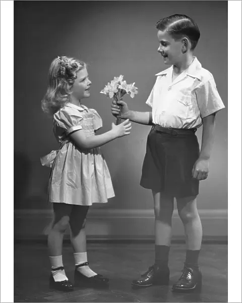 Boy giving flowers to girl