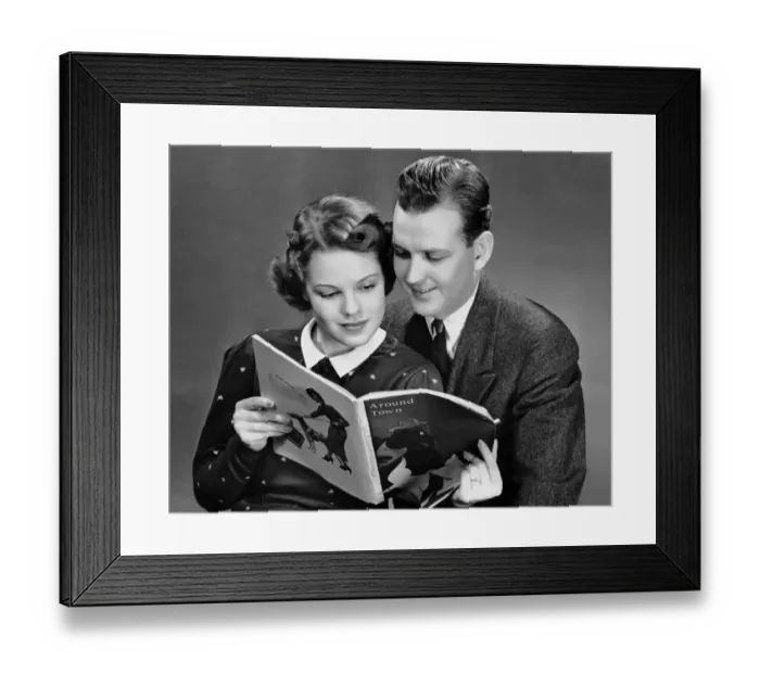 Framed Print : Couple reading magazine together