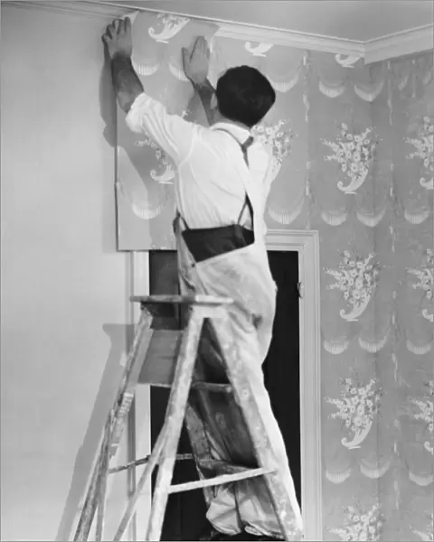 Man applying wallpaper