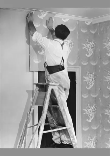 Man applying wallpaper