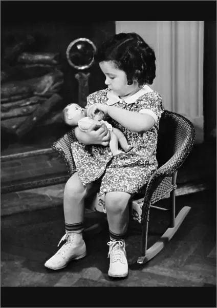 Little girl playing with doll