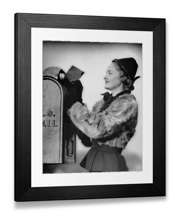 Framed Print : Woman dropping letter into mailbox Framed Print : Woman dropping letter into mailbox