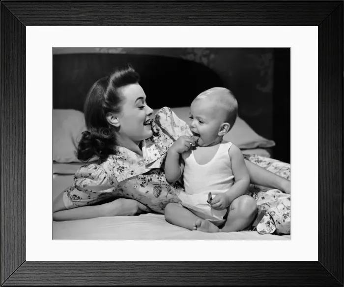 Framed Print : Mother watching baby eat cookie Framed Print : Mother watching baby eat cookie