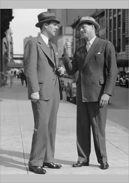 Two men talking on street