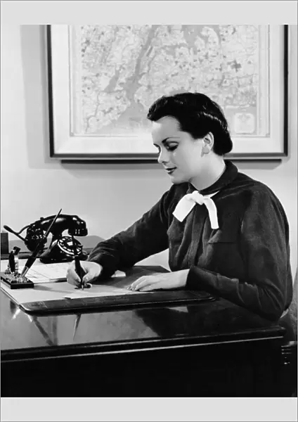 Woman writing at desk