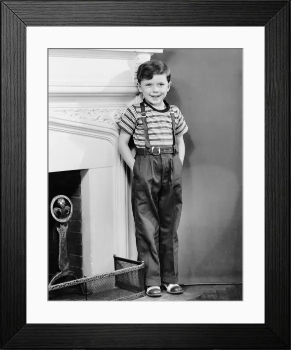 Framed Print : Boy leaning against wall by fireplace Framed Print : Boy leaning against wall by fireplace