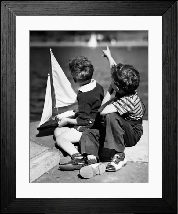 Framed Print : Two boys Playing with sailboats