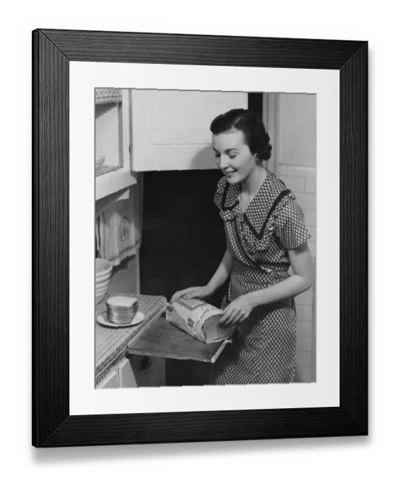 Framed Print : Woman placing bread on plate Framed Print : Woman placing bread on plate
