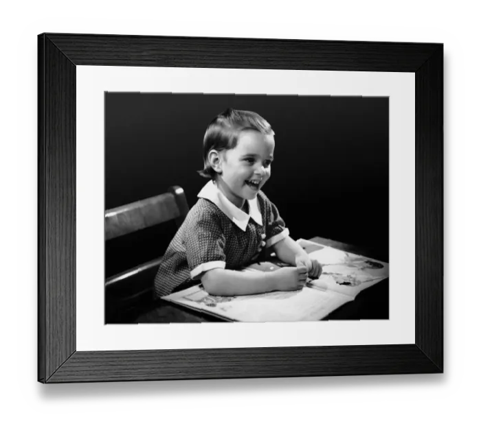 Framed Print : Smiling young girl reading book