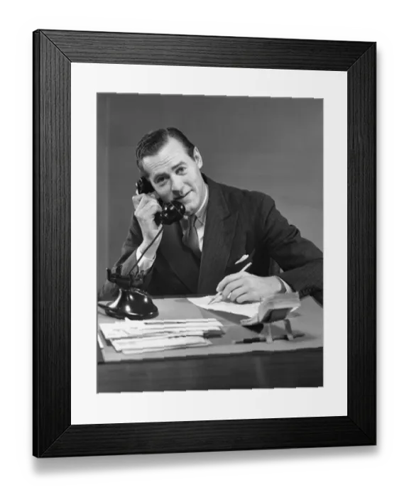 Framed Print : Businessman at desk on telephone Framed Print : Businessman at desk on telephone