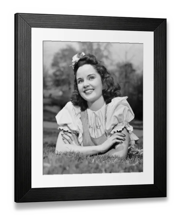 Framed Print : Teenage girl lying on grass Framed Print : Teenage girl lying on grass