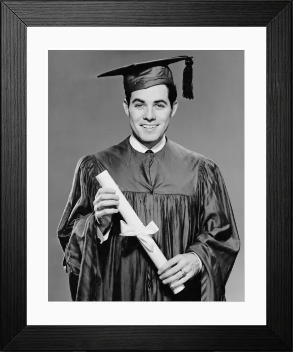 Framed Print : Young man in cap & gown holding diploma Framed Print : Young man in cap & gown holding diploma