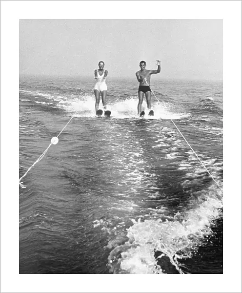 Couple water skiing