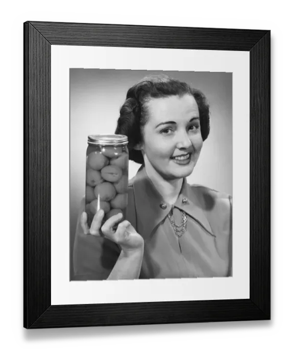 Framed Print : Woman holding jar of fruit Framed Print : Woman holding jar of fruit