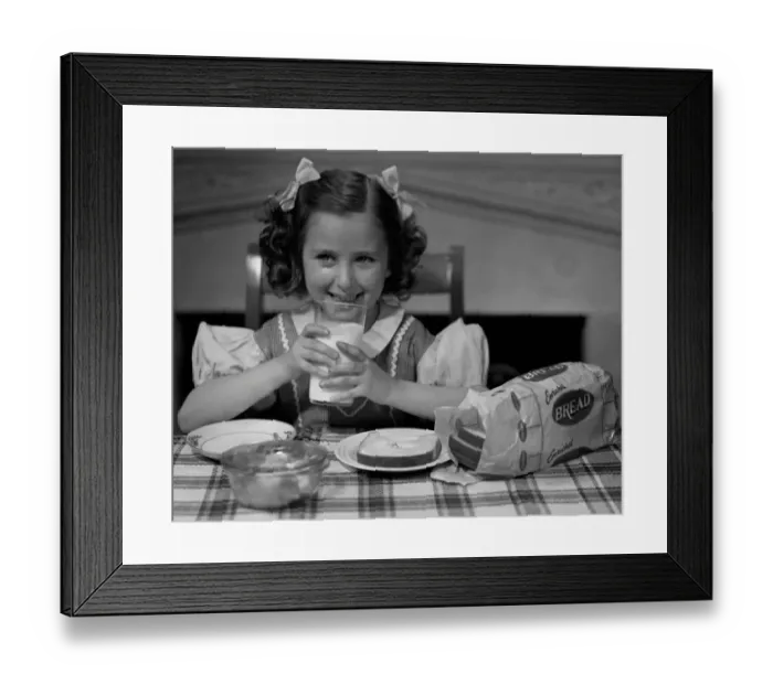 Framed Print : Girl drinking a glass of milk Framed Print : Girl drinking a glass of milk