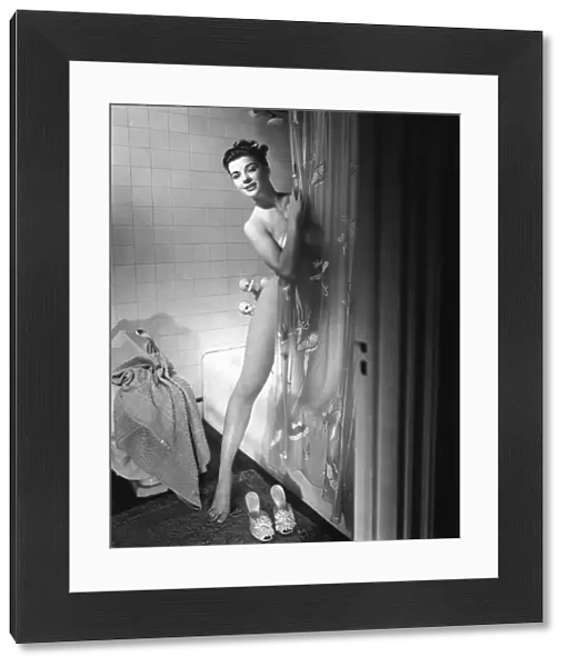 Woman behind shower curtain