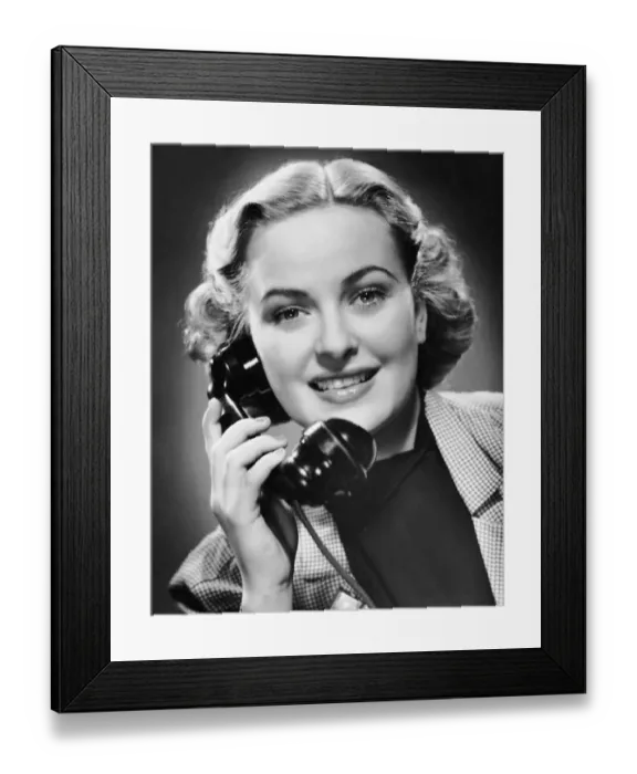 Framed Print : Indoor portrait of woman on telephone Framed Print : Indoor portrait of woman on telephone