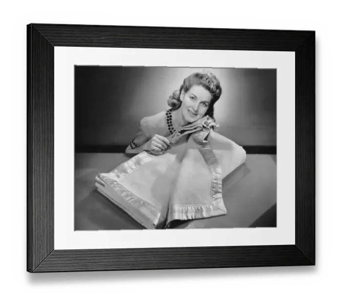 Framed Print : Woman rubbing blanket against her cheek Framed Print : Woman rubbing blanket against her cheek