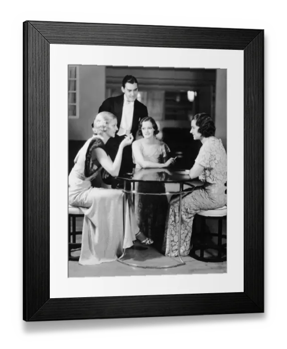 Framed Print : Man talking with three women in evening wear Framed Print : Man talking with three women in evening wear