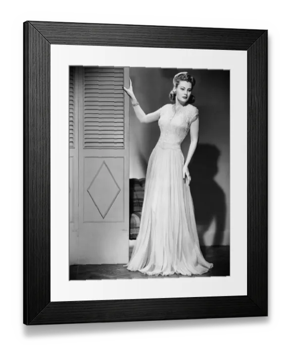 Framed Print : Woman in evening dress posing next to door Framed Print : Woman in evening dress posing next to door