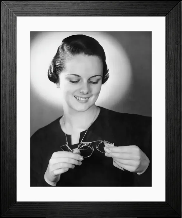 Framed Print : Portrait of woman cleaning eyeglasses Framed Print : Portrait of woman cleaning eyeglasses
